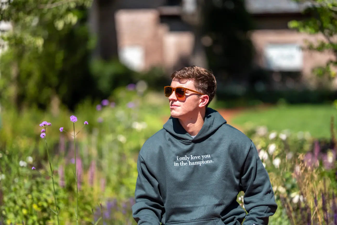 Portrait in the wildflowers with green hoodie